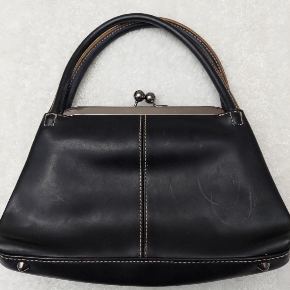 Faux leather small handbag.  Old fashioned clap for closure.  Satchel style
